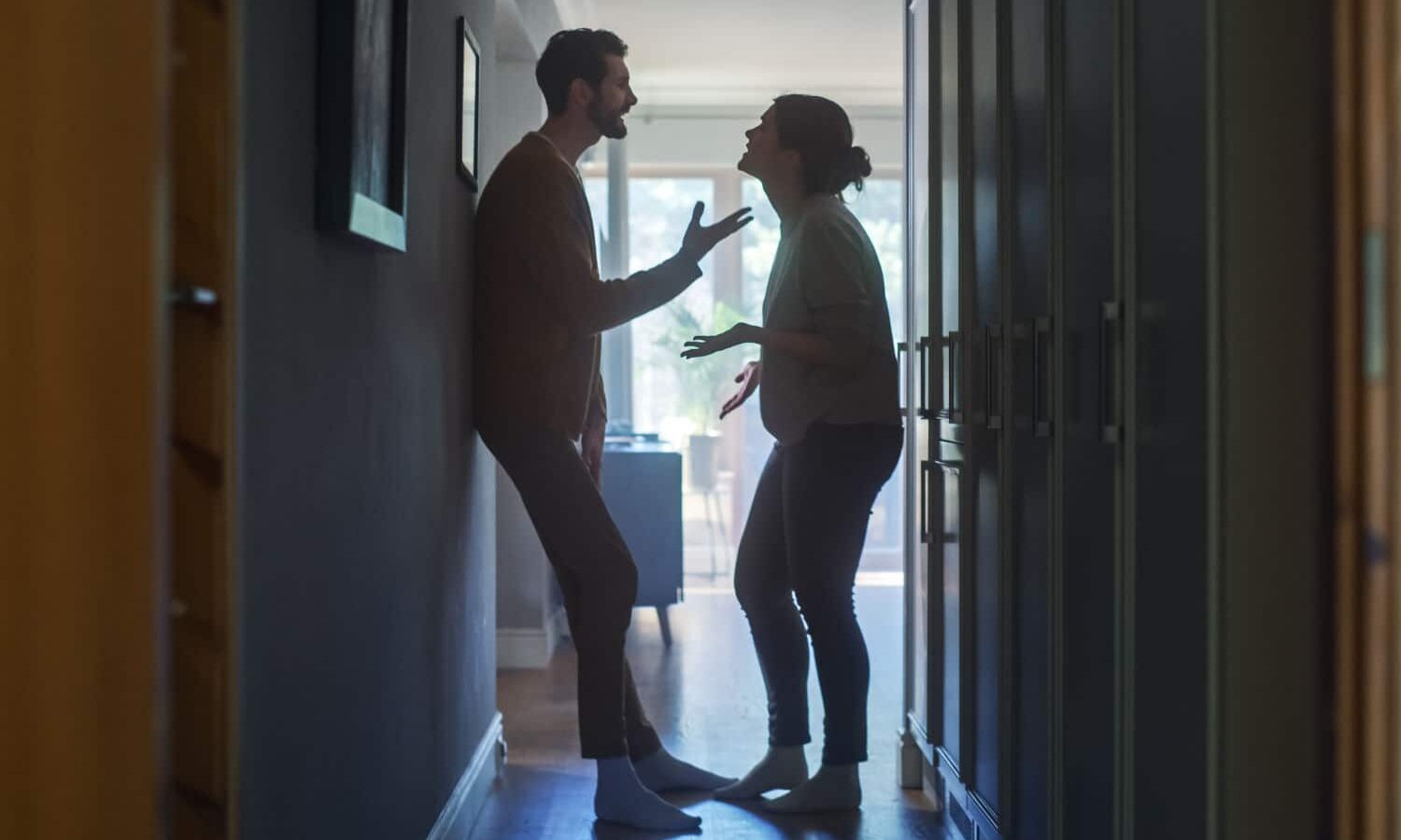 two people arguing in a hallway Two people arguing in a hallway