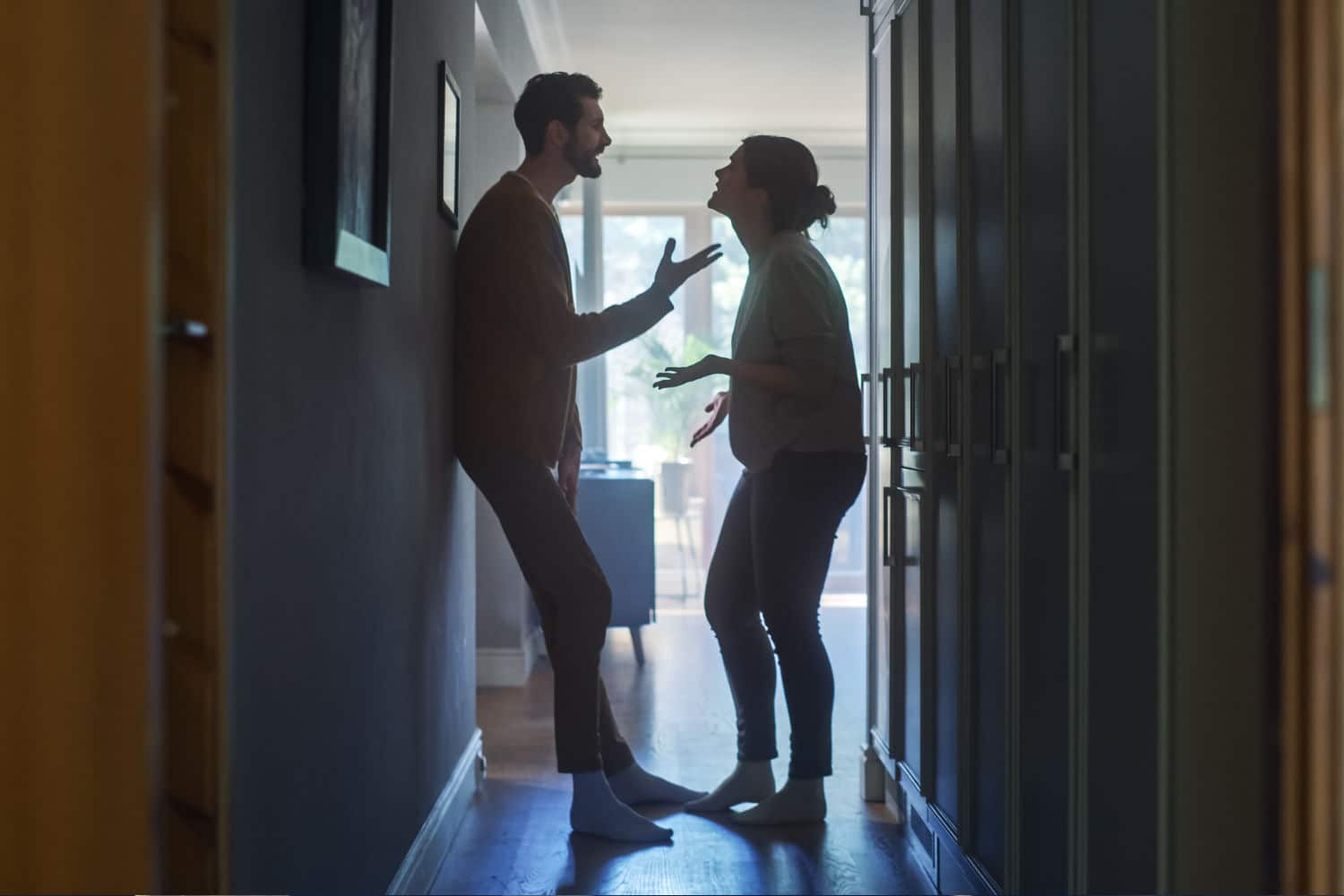Two people arguing in a hallway